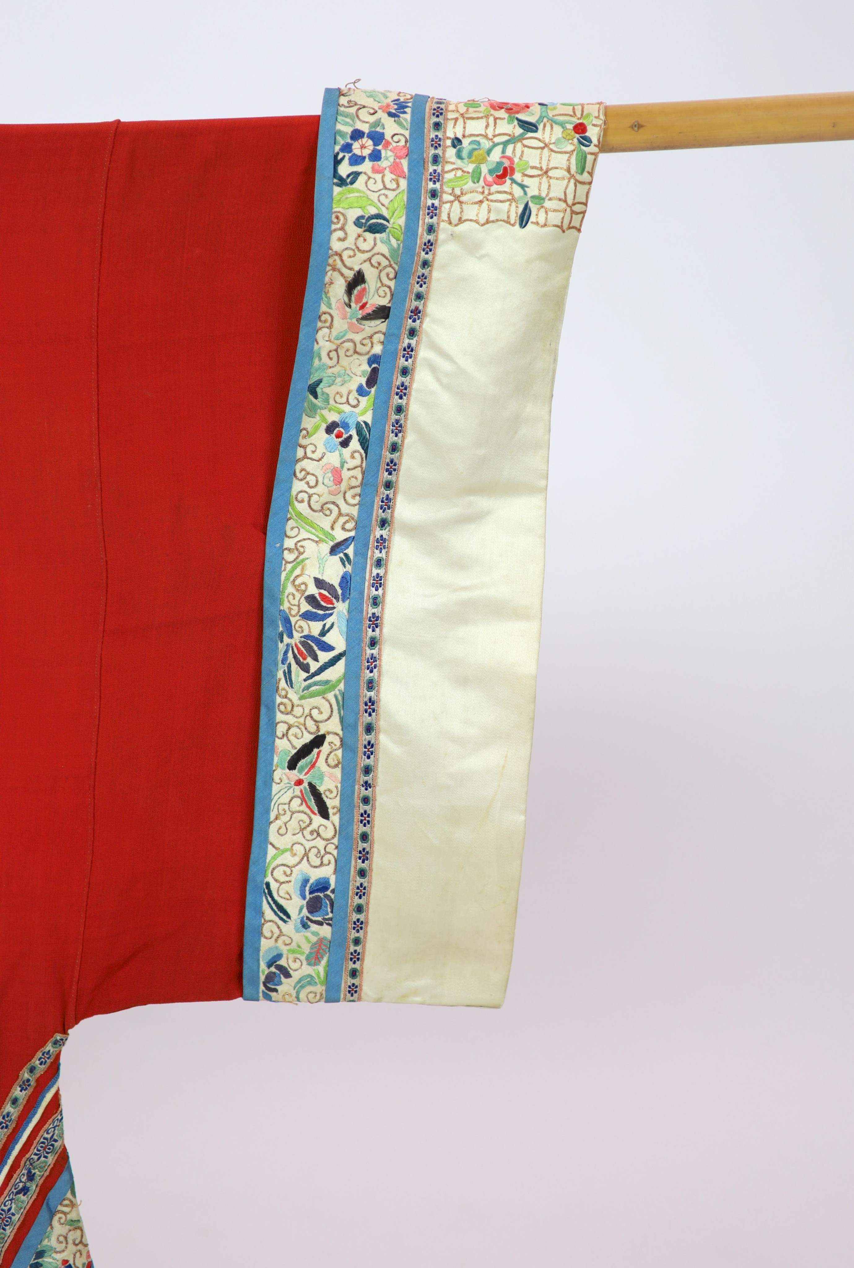A Chinese red silk robe, late 19th century, 102cm drop